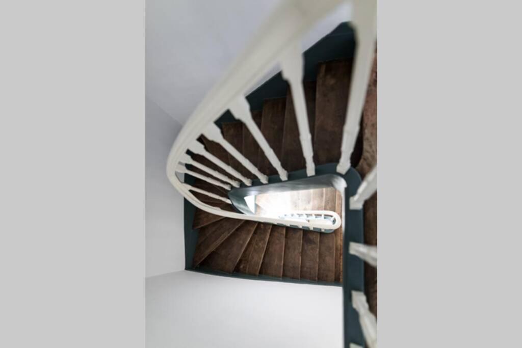 a spiral staircase in a house at La Villa de l&#39;Etoile jacuzzi privé chauffé à 37°C in Forges-les-Eaux