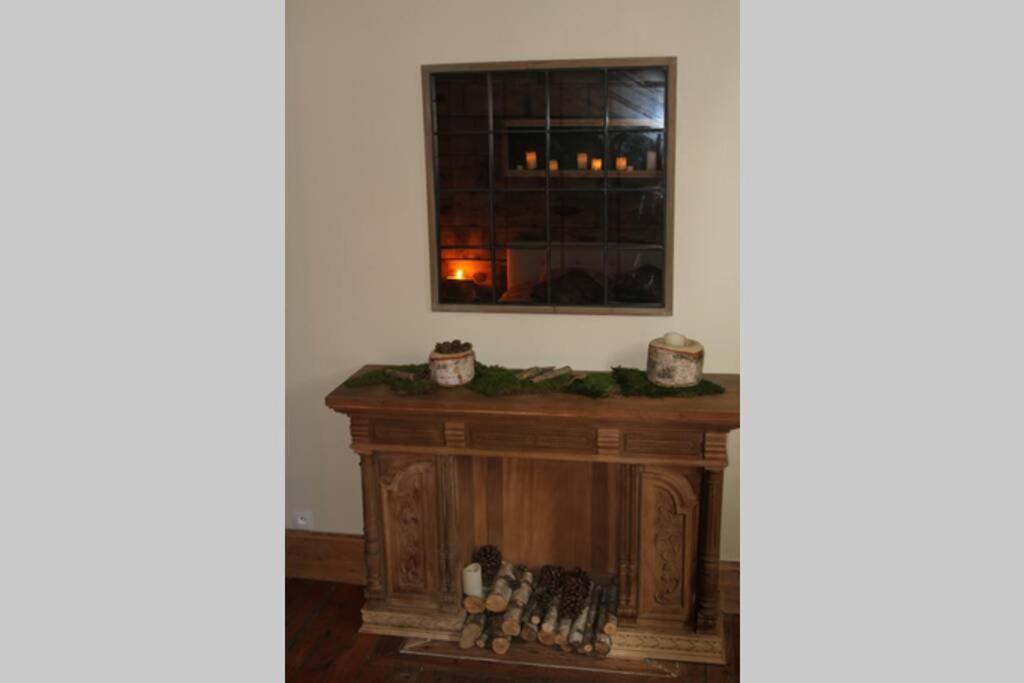 a fireplace in the corner of a room with a window at La Villa de l&#39;Etoile jacuzzi privé chauffé à 37°C in Forges-les-Eaux