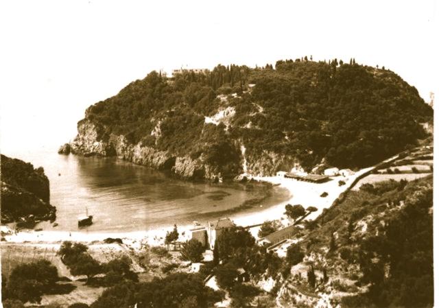 a black and white photo of a beach with a mountain at Zefiros Traditional Hotel in Paleokastritsa