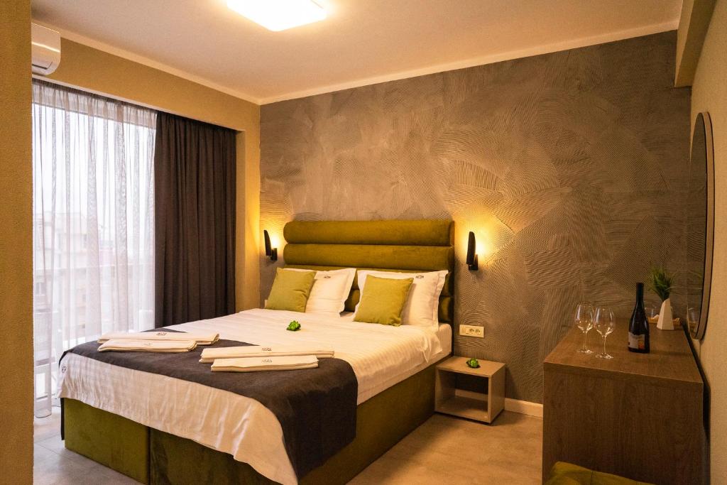 a bedroom with a large bed with towels on it at Lotus Exclusive in Mamaia Nord