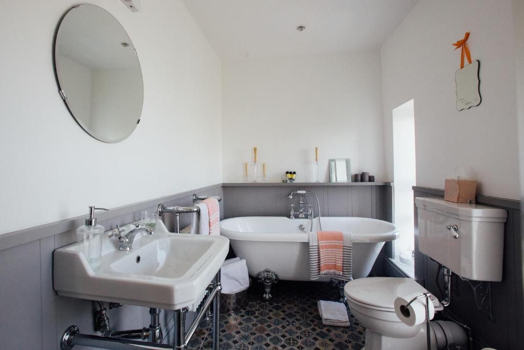 a bathroom with a sink and a tub and a toilet at Tom Blake House in Kells