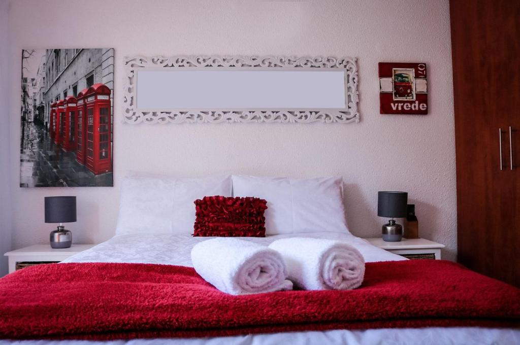 a bedroom with a bed with two towels on it at La Grâce, Durbanville in Cape Town