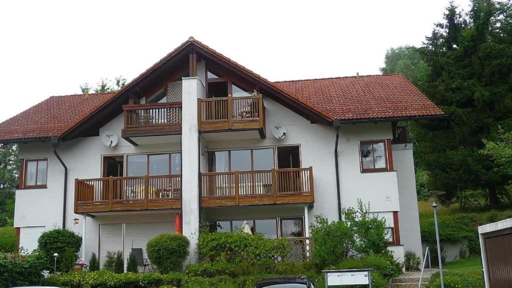 a large white house with wooden balconies on it at Komfort-Fewo Sylvia in Spiegelau