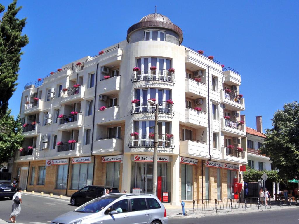 a large white building with a round at St. George Apartments in Nesebar