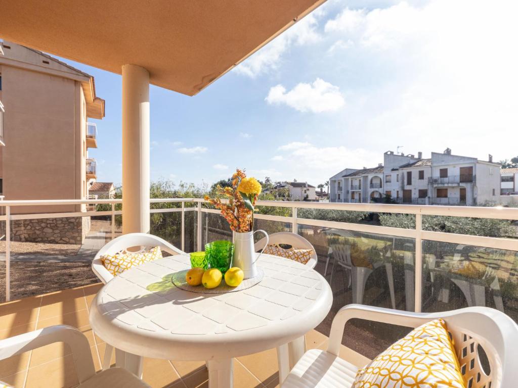 a white table and chairs on a balcony at Apartment Roquemar by Interhome in L'Ampolla