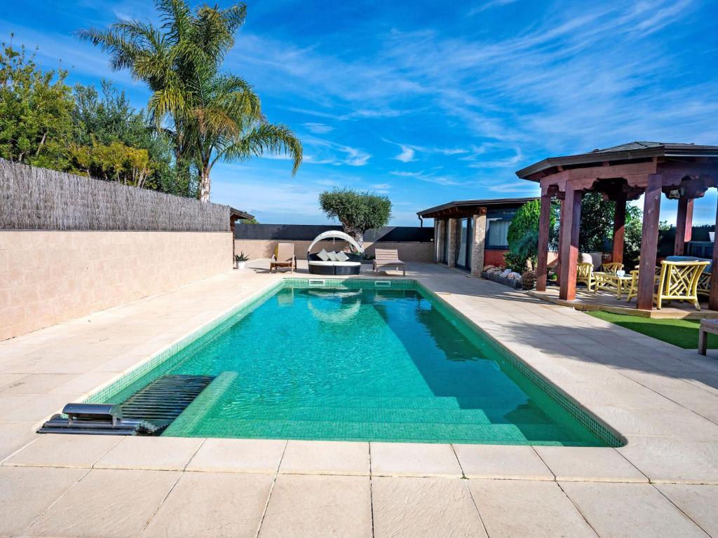 a swimming pool in the middle of a yard at Holiday Home Masia Blanca by Interhome in Comarruga