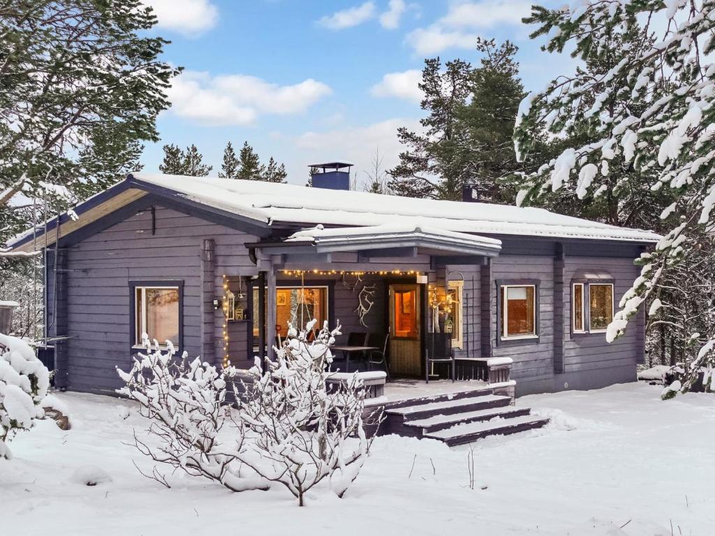 a tiny house in the snow with a porch at Holiday Home Riekkotupa by Interhome in Enontekiö