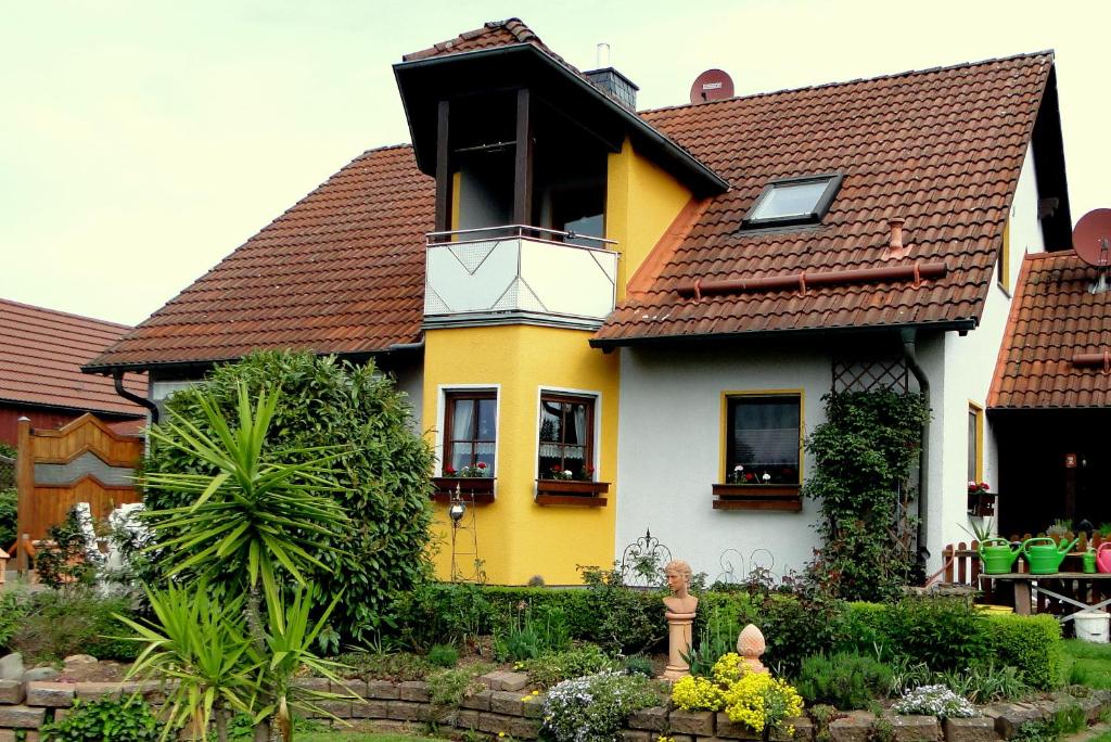 una casa gialla e bianca con tetto marrone di Ferienwohnung Am Klosterberg 6 a Bad Brückenau