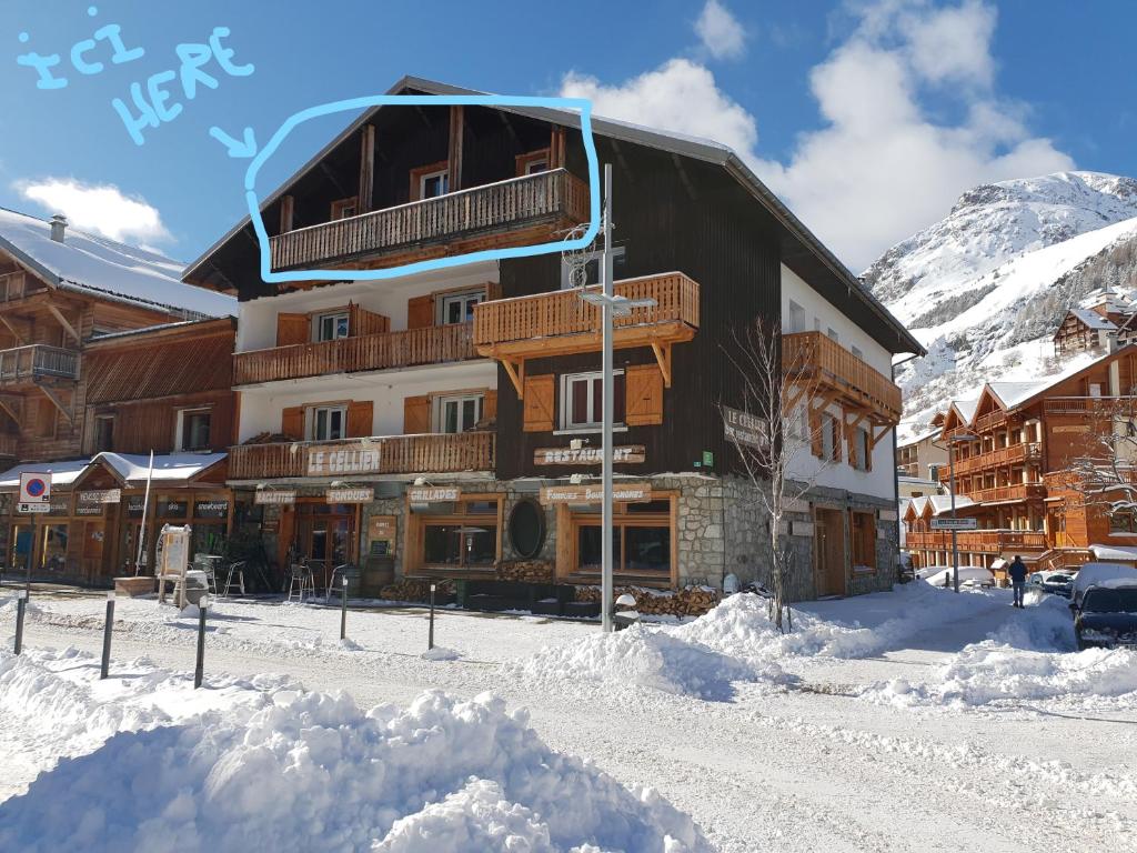a building in the snow in front of a mountain at 130m2 ,5 chambres, trés bien situé in Les Deux Alpes