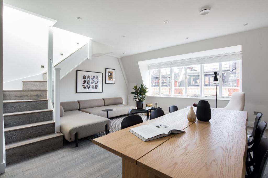 a living room with a table and a couch at Hausd - Leicester Square in London