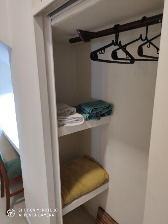 um pequeno armário com uma prateleira e algumas toalhas em Zona centrica dentro de las cuatro avenidas. em Santiago del Estero