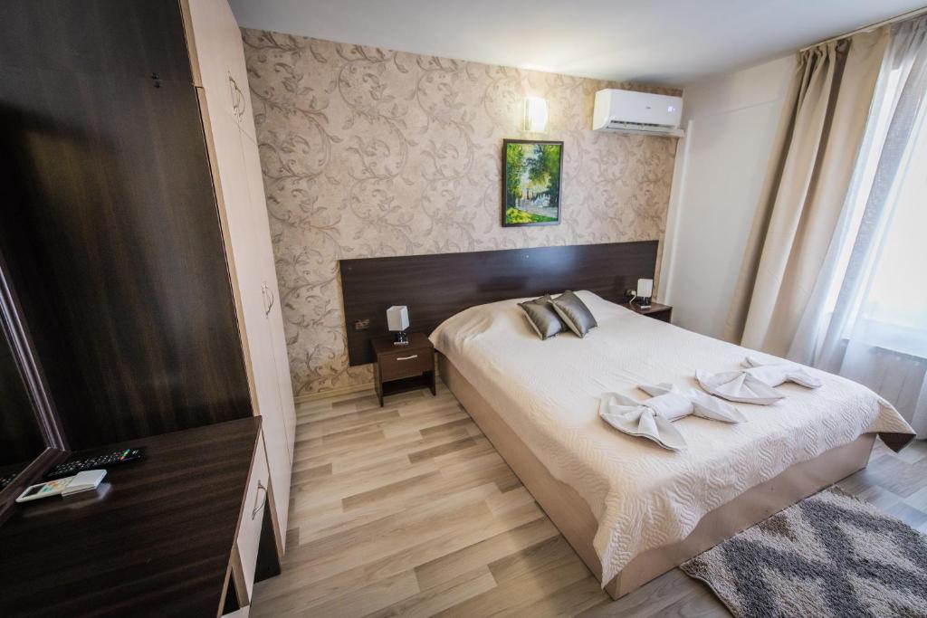 Postel nebo postele na pokoji v ubytování Vida Family Hotel