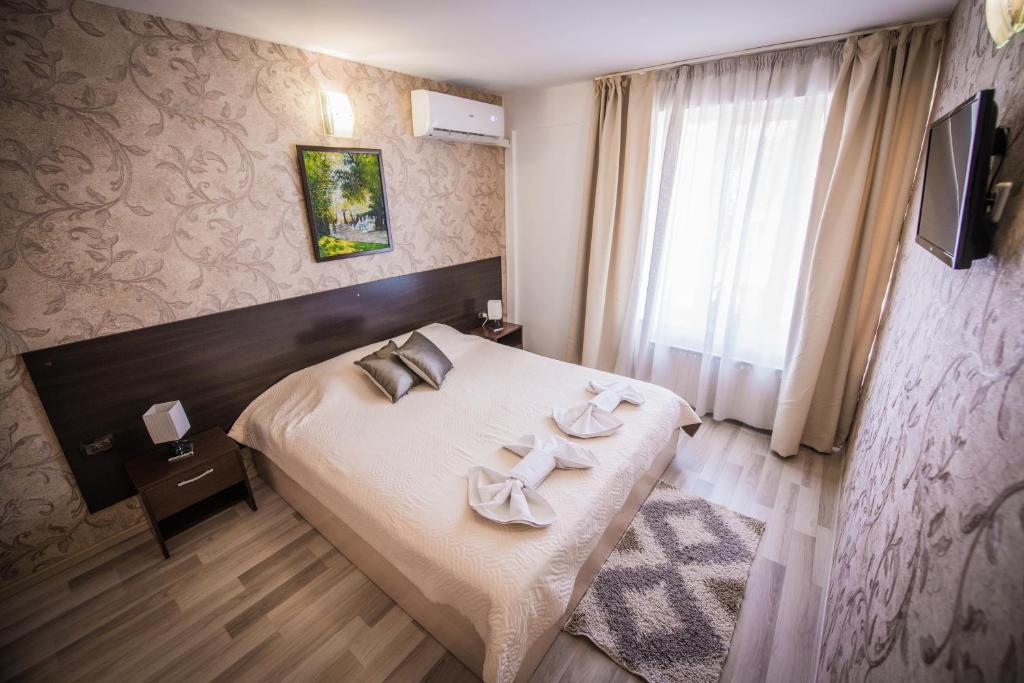 Postel nebo postele na pokoji v ubytování Vida Family Hotel