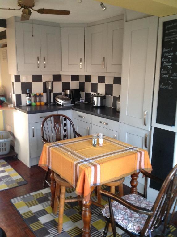 a kitchen with a table with chairs and a counter top at JOE'S PLACE in Retford