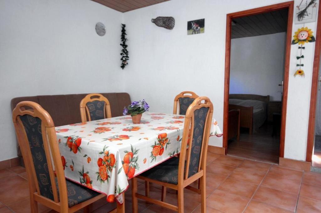 stół jadalny z kwiatowym obrusem w obiekcie Apartment Basina (3450-2) w mieście Stari Grad