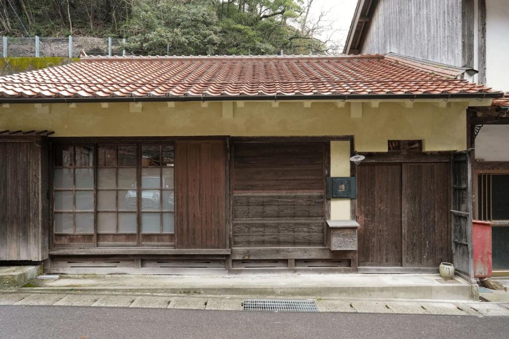 a small house with wooden doors on a street at Light Tomoru - Vacation STAY 25289v in Oda
