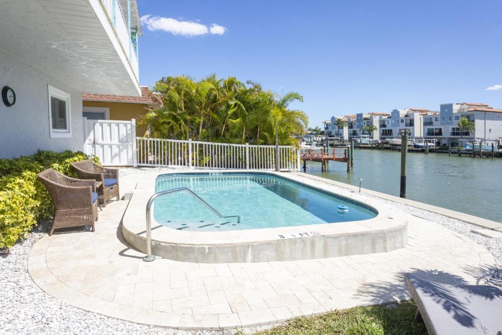 a swimming pool on a patio next to a house at Waterfront & Pool B Star5Vacations in St Pete Beach