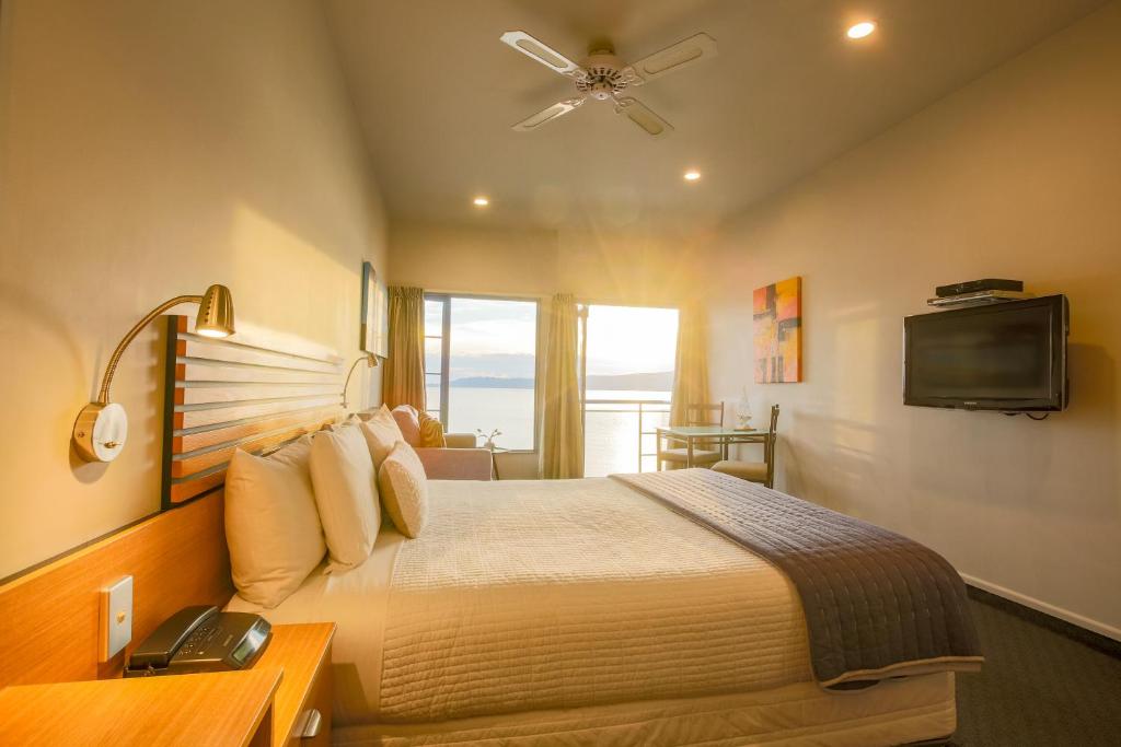 a hotel room with a bed and a television at Clearwater Motor Lodge in Taupo