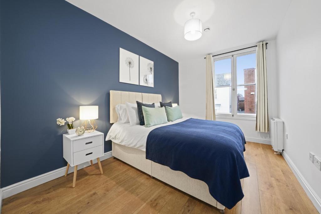 - une chambre avec un mur bleu et un lit dans l'établissement Central Gem of Leamington Spa - Sleeps 5, à Leamington Spa