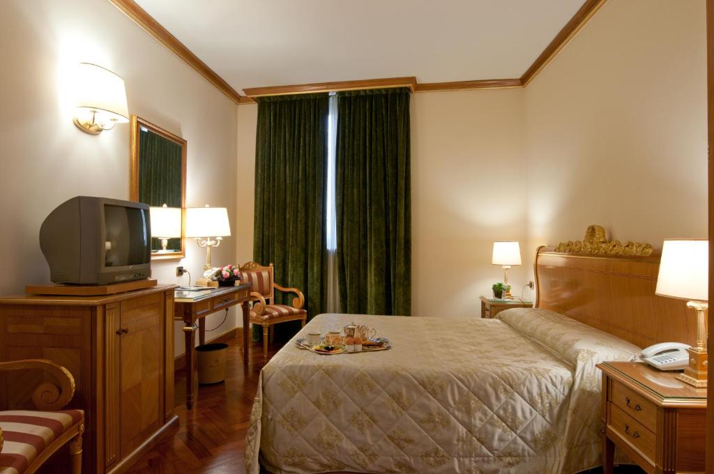 Postel nebo postele na pokoji v ubytování Hotel Marconi