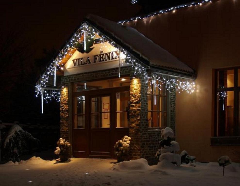 a building with a sign that reads vita pizza with lights at Vila Fenix B&B in Ružomberok