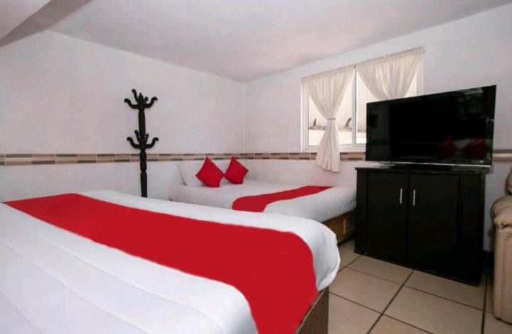Postel nebo postele na pokoji v ubytování Hotel Real Cortés