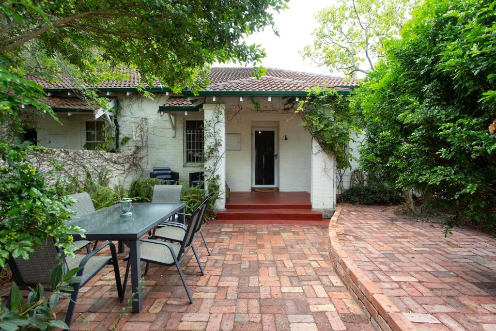 a patio with a table and chairs in front of a house at Soloman Street Cottage in Fremantle