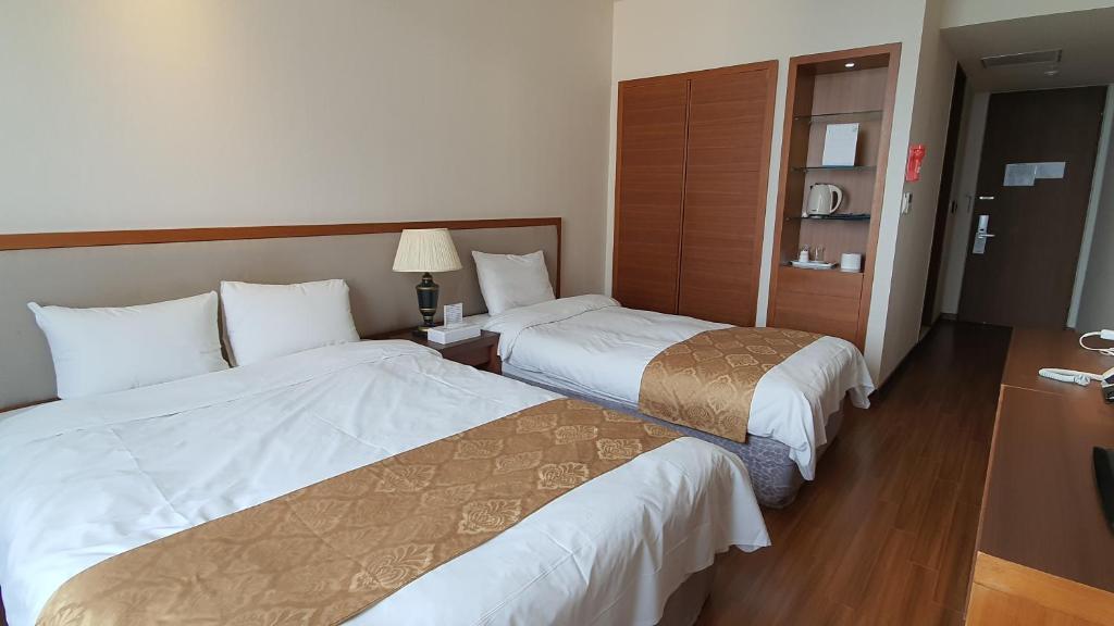 Postel nebo postele na pokoji v ubytování Gyungpo Beach Hotel