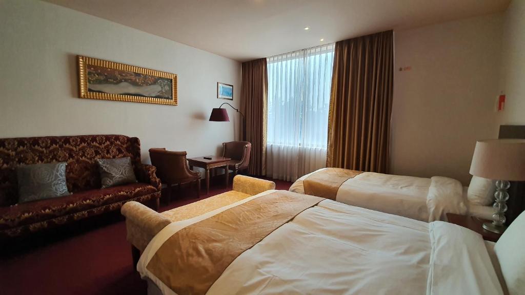 Postel nebo postele na pokoji v ubytování Gyungpo Beach Hotel