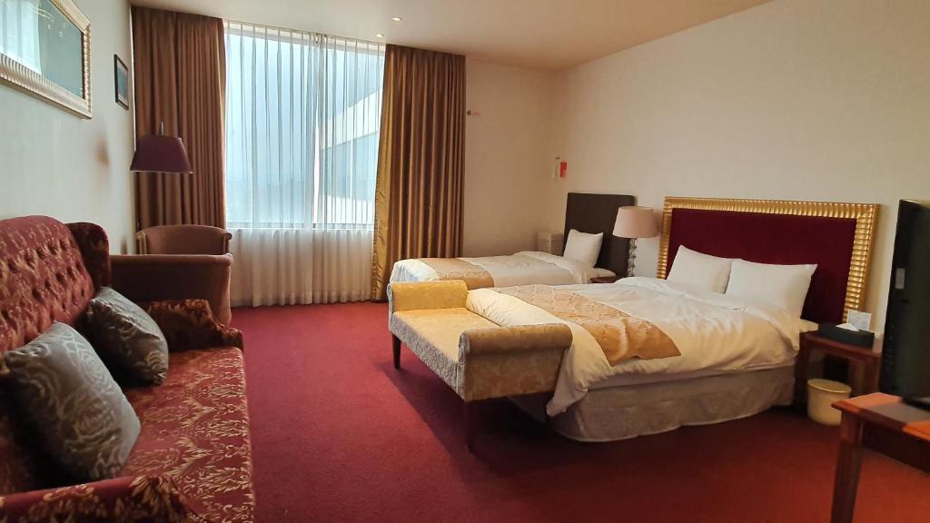 Postel nebo postele na pokoji v ubytování Gyungpo Beach Hotel