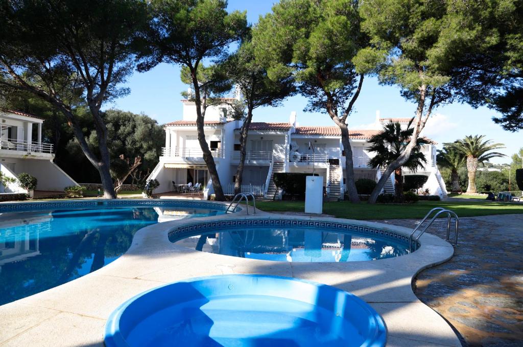 a swimming pool in front of a house at Villa Pilar in Es Mercadal