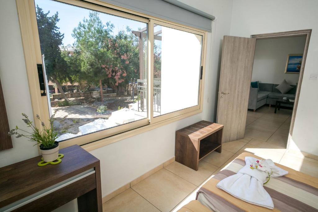a living room with a large window and a couch at Crystallo Apartments in Paphos