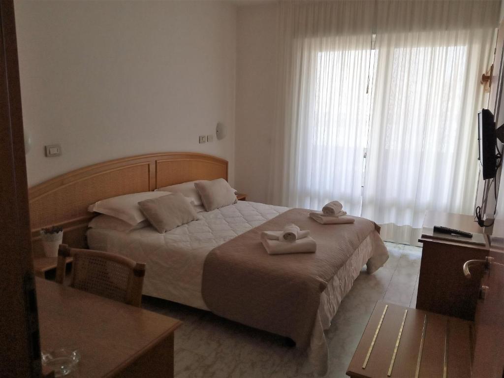 Postel nebo postele na pokoji v ubytování Hotel Capri