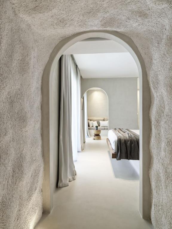 A bed or beds in a room at Mykonos Earth Suites
