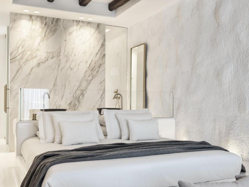 A bed or beds in a room at Mykonos Earth Suites