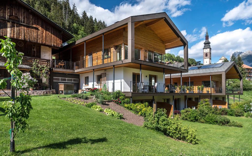 a large house with a grass yard in front of it at Peterwieshof in Funes