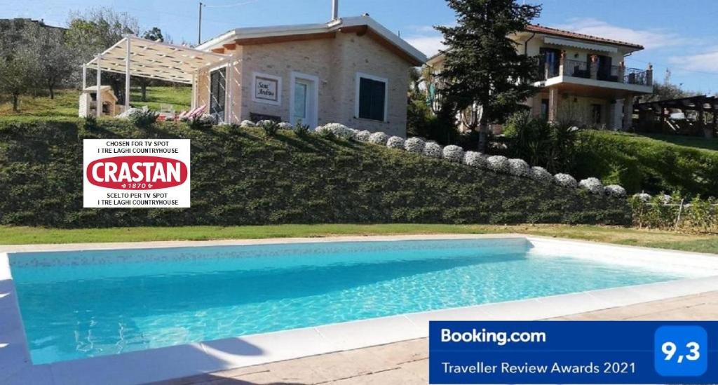a house with a sign in front of a swimming pool at Cottage with pool,views in Citta' Sant'Angelo