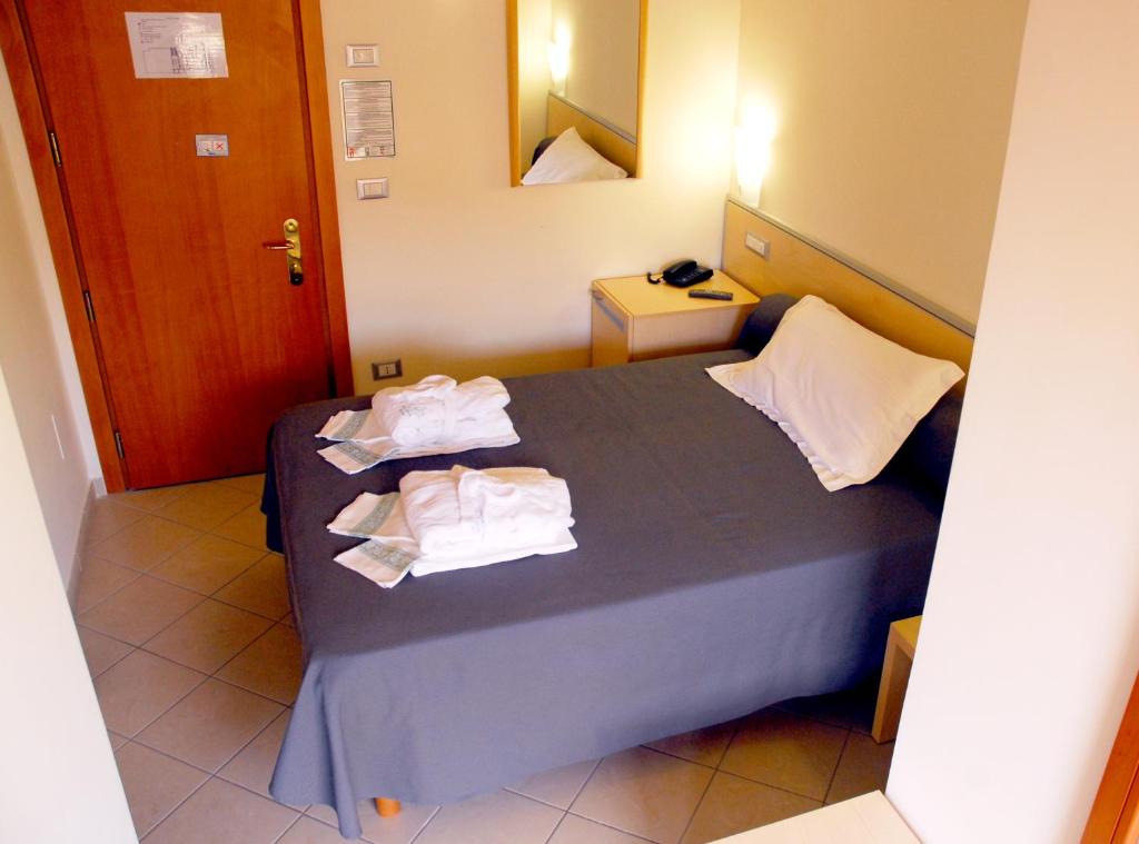 Postel nebo postele na pokoji v ubytování Grazia Hotel