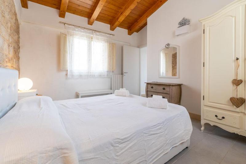 Łóżko lub łóżka w pokoju w obiekcie Baglio Cella - Appartamenti per Vacanze