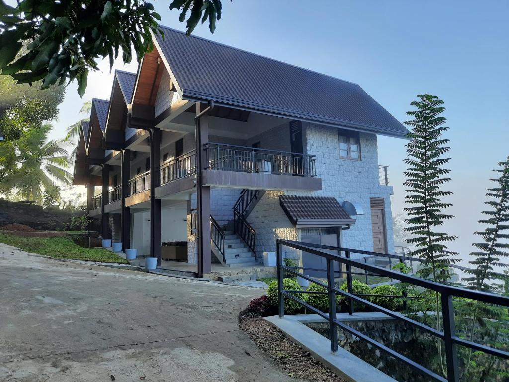 a large house with stairs and a balcony at Terrace Cinnamon View in Ratnapura