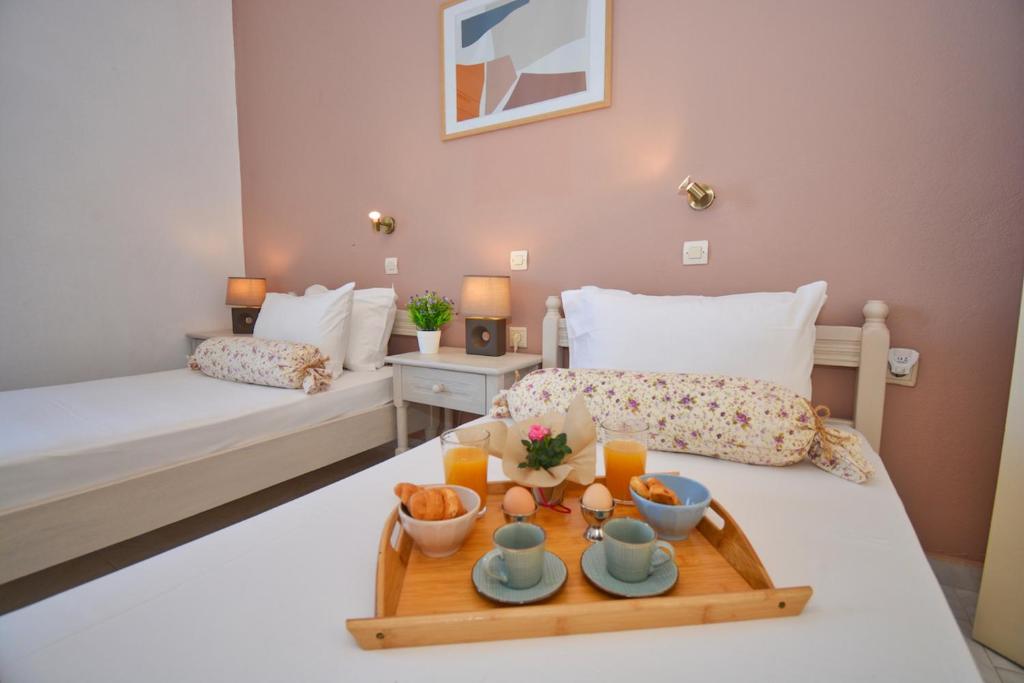 a tray of food on a table in a bedroom at Despoina's Apartment in Vátos