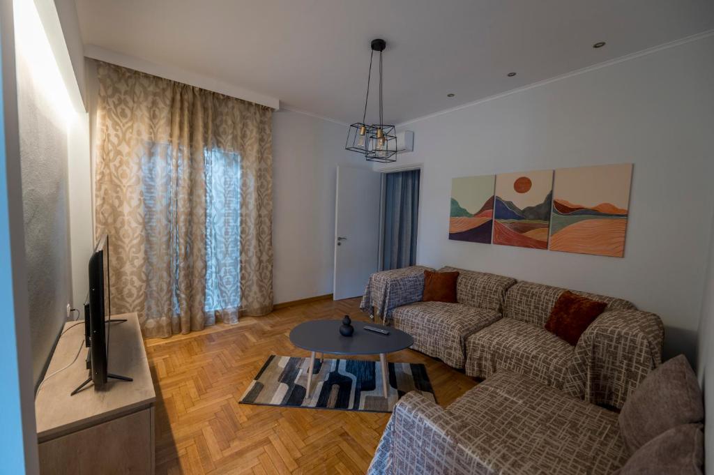 a living room with a couch and a table at Kliton Comfort Portaremounta Apartment in Corfu