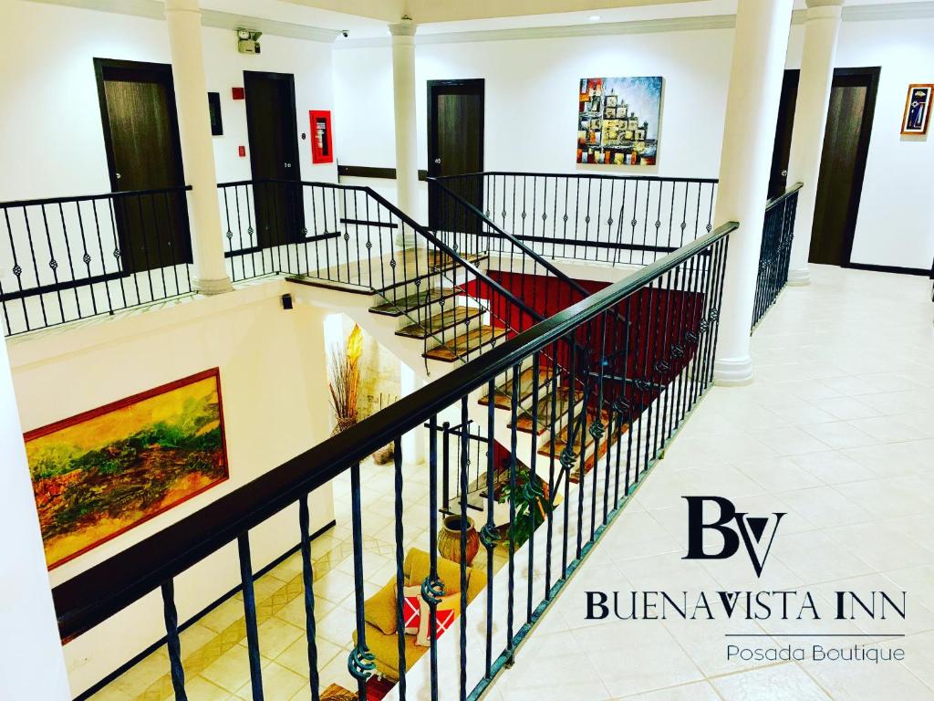 a staircase in a building with art on the walls at BUENAVISTA INN in Maiquetía