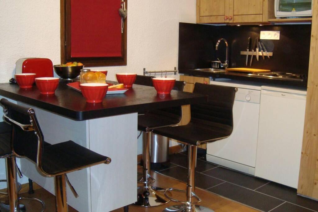 a kitchen with a counter with red bowls on it at Val Thorens 2 bedrooms 6 persons next slopes in Val Thorens