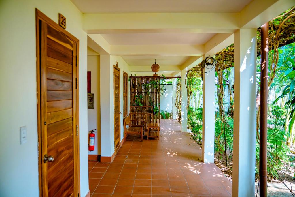 a hallway of a house with a door at La Mer Resort, Phú Quốc in Phú Quốc