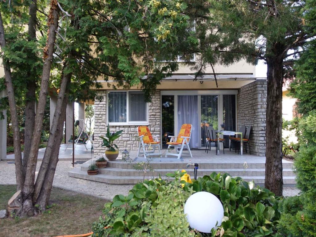 a house with chairs and a table on a patio at Apartment in Siofok-Sosto/Balaton 38178 in Balatonszabadi Fürdőtelep