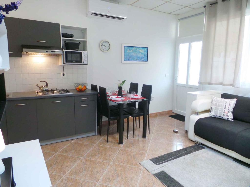 a kitchen and living room with a table and a couch at Apartment in Umag/Istrien 37005 in Umag