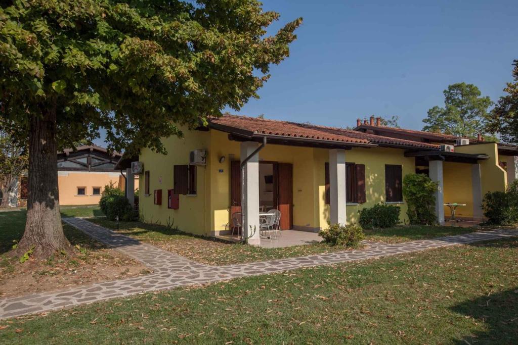 a yellow house with a tree in front of it at Holiday Homes in Sirmione/Gardasee 22174 in Sirmione