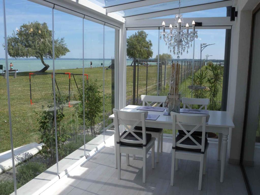 a white table and chairs on a patio with a view of the ocean at Studio in Siofok/Balaton 27759 in Siófok