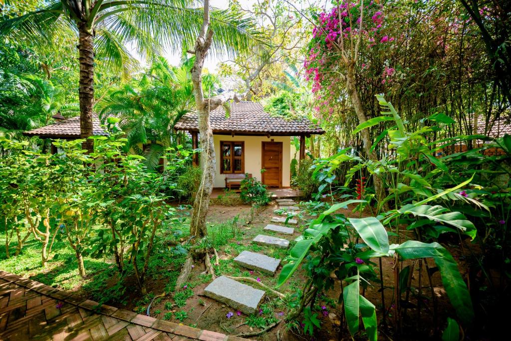a small house in the middle of a garden at La Mer Resort, Phú Quốc in Phú Quốc